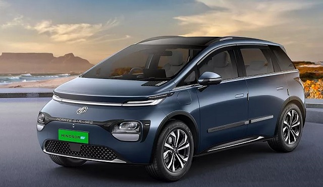 MG Windsor EV sedan showcased under showroom lights highlighting sleek profile