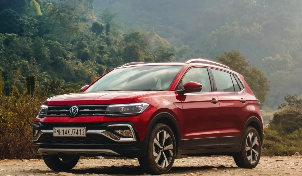 Volkswagen Taigun 2025 side profile in bright yellow, showcasing sporty alloy wheels and bold shoulder line under Diwali offer signage
